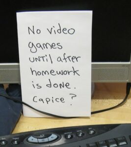 Sign that reads "No video games until after homework is done. Capice?"